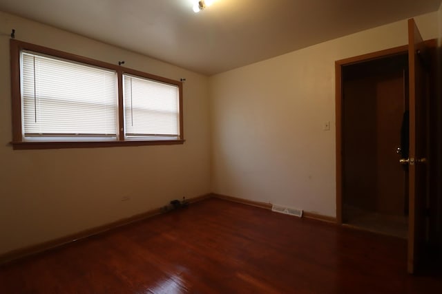 unfurnished room featuring dark hardwood / wood-style floors