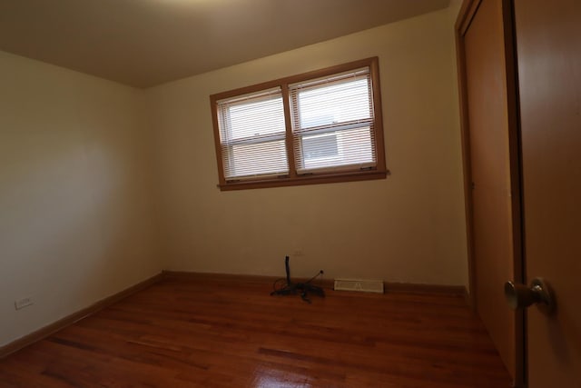 spare room featuring dark hardwood / wood-style flooring