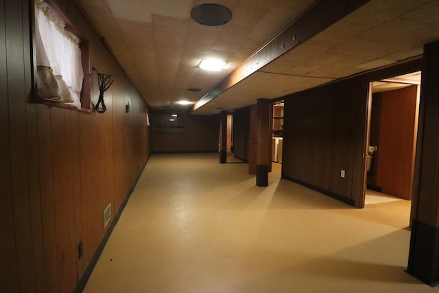 basement featuring wood walls