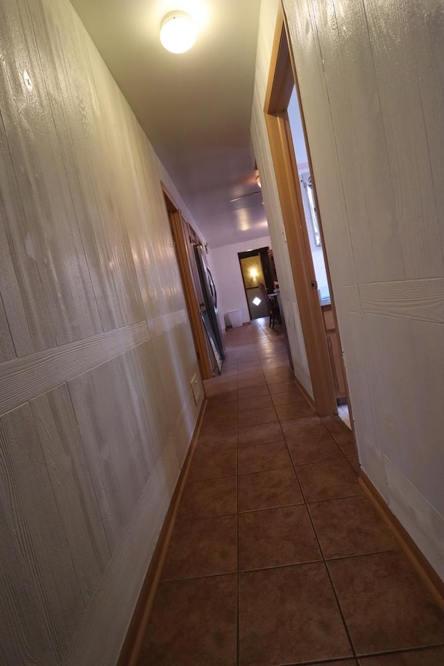 hallway featuring dark tile patterned flooring