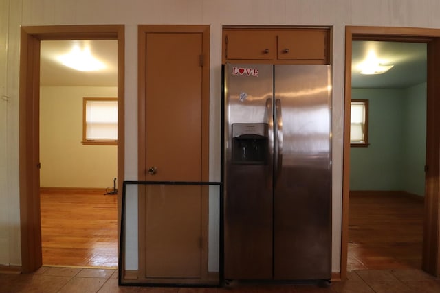 kitchen featuring stainless steel fridge and light tile patterned floors