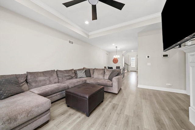 living room featuring light hardwood / wood-style floors, ceiling fan with notable chandelier, and ornamental molding