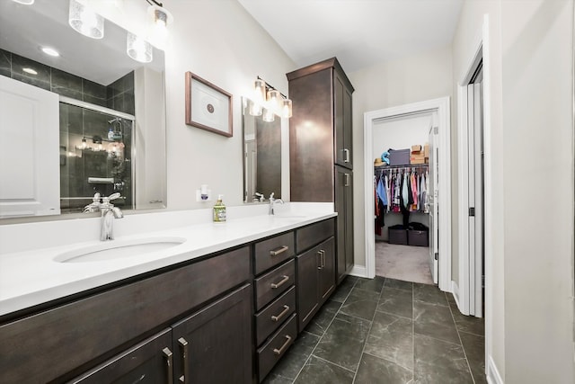 bathroom with vanity, tile patterned floors, and a shower with door