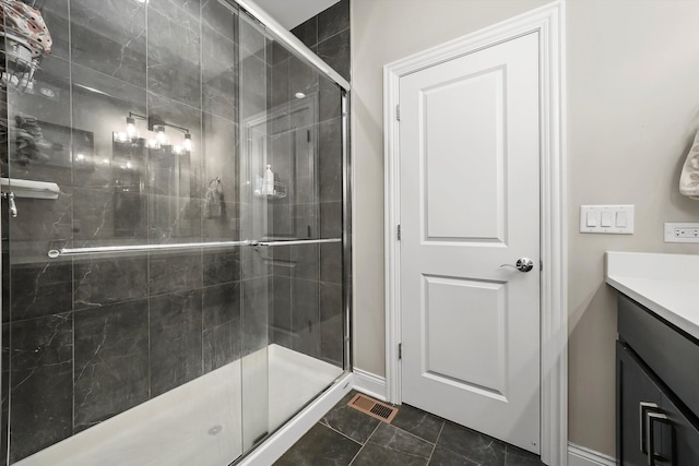 bathroom featuring walk in shower, tile patterned flooring, and vanity