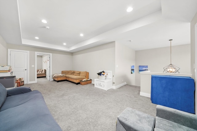 living room with carpet and a raised ceiling