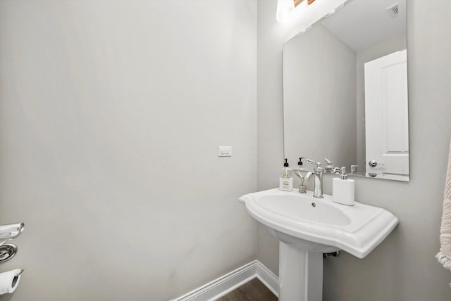 bathroom with hardwood / wood-style floors