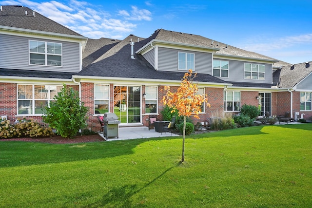 rear view of house featuring a yard