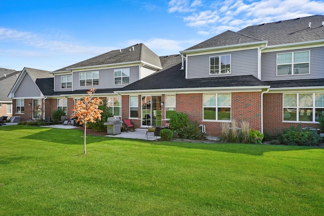 rear view of house featuring a patio and a yard