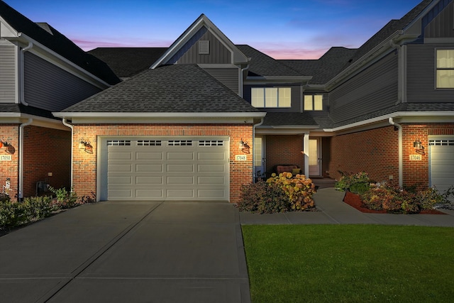 view of front of house with a garage and a yard