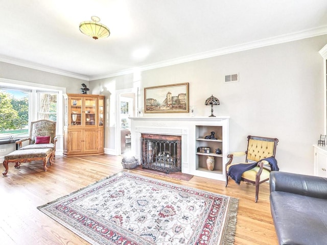 living room featuring hardwood / wood-style flooring and ornamental molding