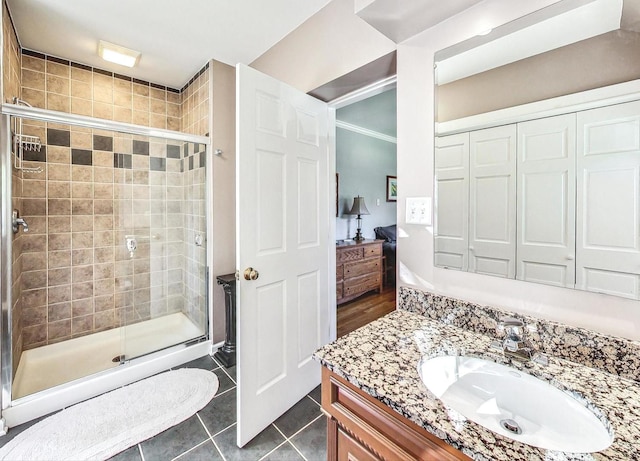 bathroom featuring vanity, tile patterned flooring, and an enclosed shower