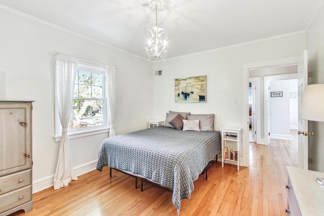 bedroom with crown molding, a notable chandelier, and light hardwood / wood-style floors