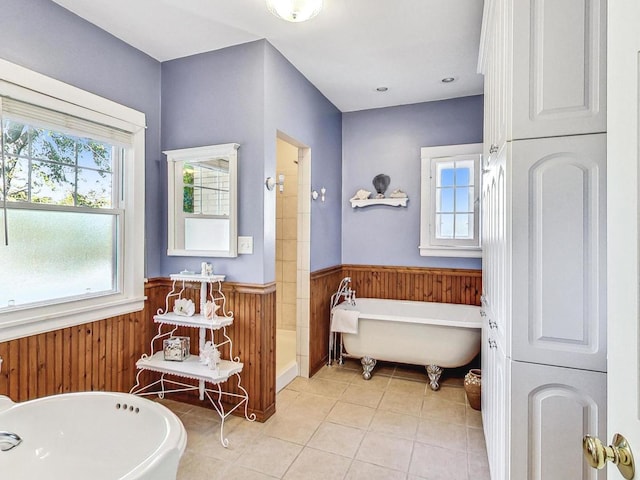 bathroom with wood walls, shower with separate bathtub, and tile patterned floors