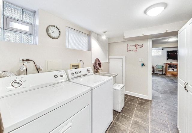 washroom with sink, tile patterned floors, and washing machine and clothes dryer