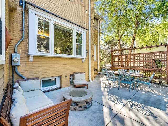 view of patio featuring an outdoor living space with a fire pit