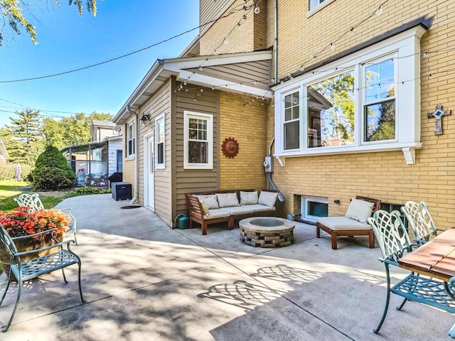 view of patio featuring an outdoor living space with a fire pit