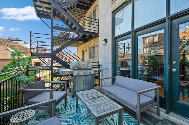 balcony with an outdoor living space and grilling area