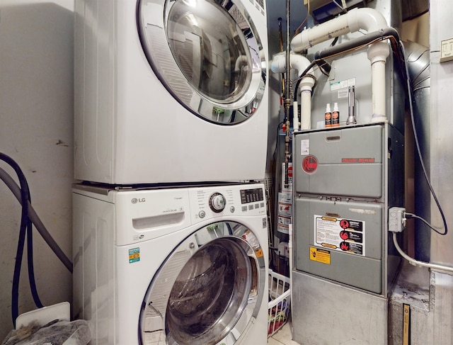 laundry room with stacked washer / drying machine and heating unit