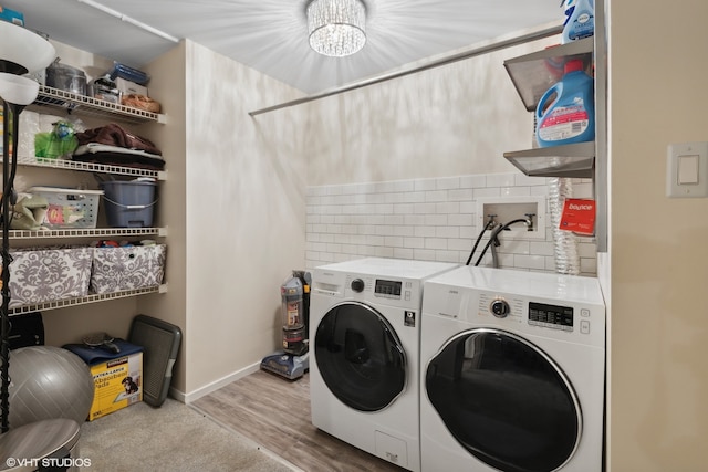 laundry room with light hardwood / wood-style flooring and washer and clothes dryer