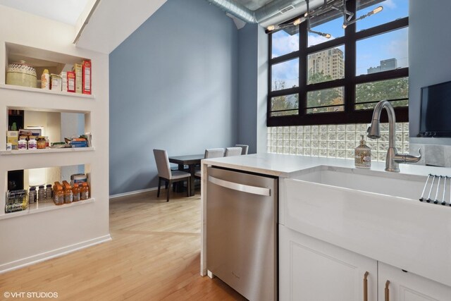 1601 S Michigan Ave Unit 108, Chicago, IL 60616 - kitchen featuring white cabinets, dishwasher, light wood finished floors, and a sink