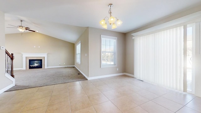 unfurnished living room with light carpet, ceiling fan with notable chandelier, and lofted ceiling