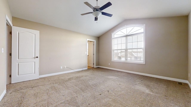 unfurnished bedroom with ceiling fan, vaulted ceiling, and light carpet