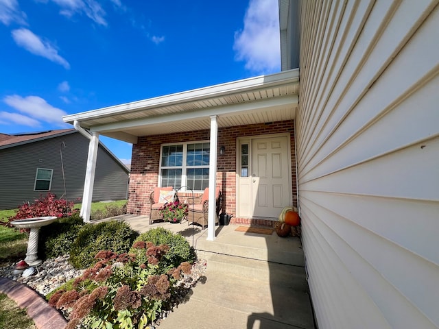 view of exterior entry featuring a porch