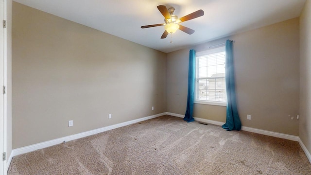 unfurnished room with light colored carpet and ceiling fan