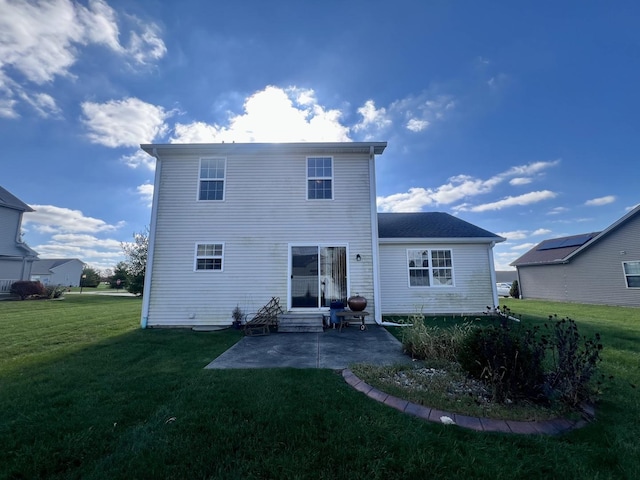 rear view of property with a yard and a patio area