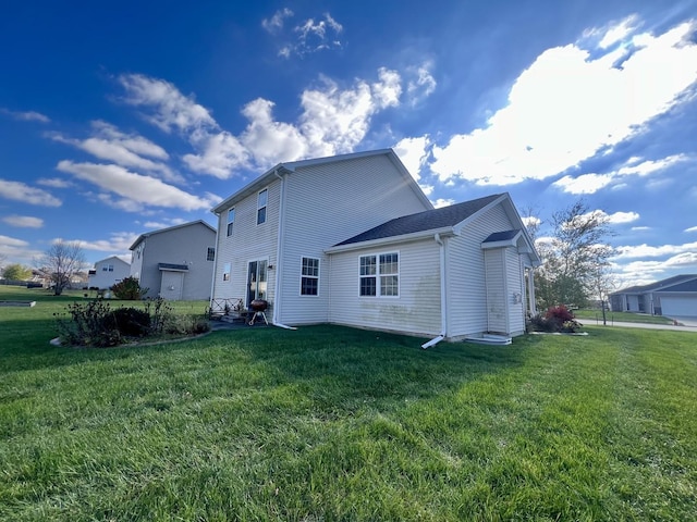 rear view of property featuring a yard