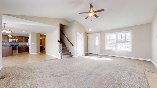 unfurnished living room with ceiling fan, vaulted ceiling, and light carpet