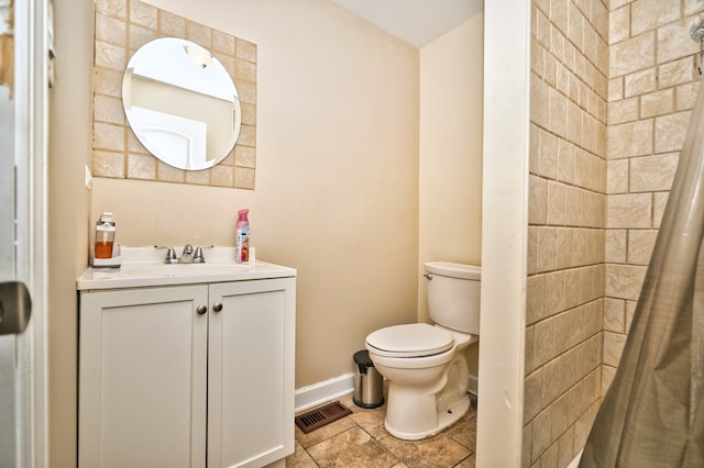 bathroom with vanity, a shower with shower curtain, and toilet