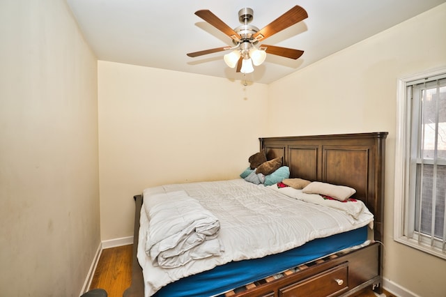 bedroom with dark wood-type flooring and ceiling fan