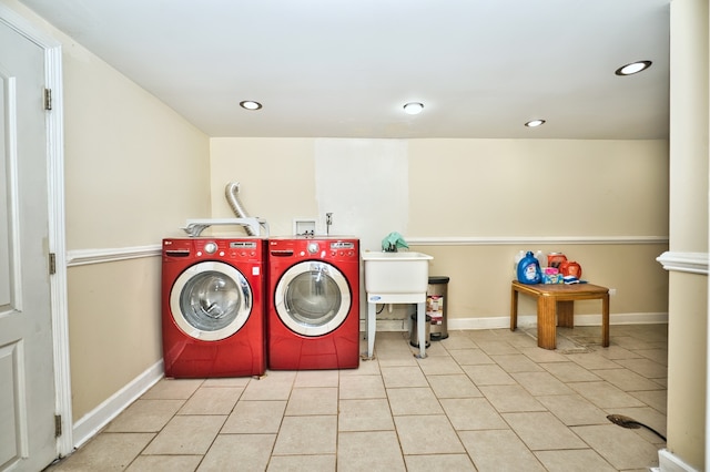 clothes washing area with independent washer and dryer and light tile patterned floors