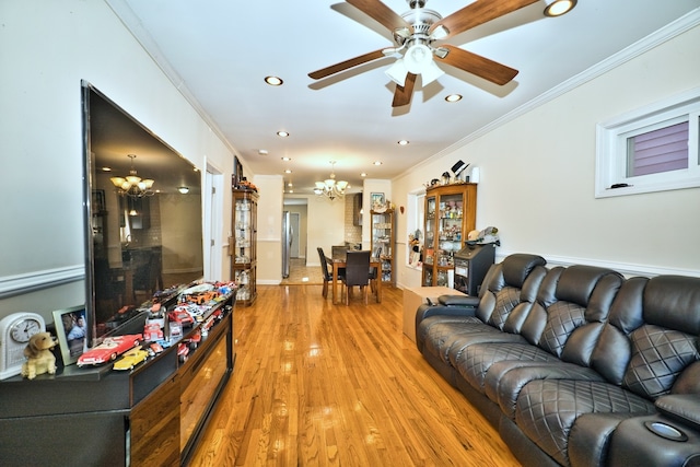 living room with crown molding, hardwood / wood-style flooring, and ceiling fan with notable chandelier