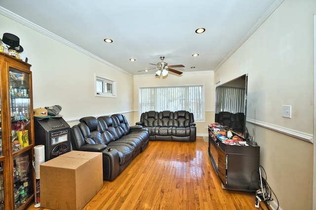 living room with crown molding, wood-type flooring, and ceiling fan