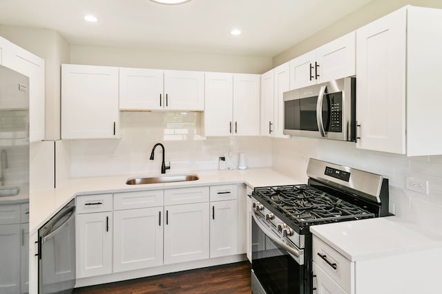 kitchen featuring appliances with stainless steel finishes, dark hardwood / wood-style floors, and white cabinetry