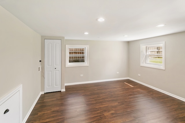 unfurnished room featuring dark wood-type flooring