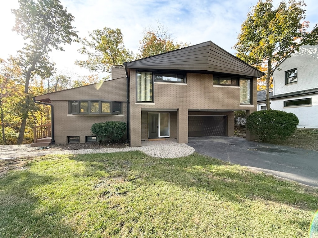 view of front of home with a front yard and a garage