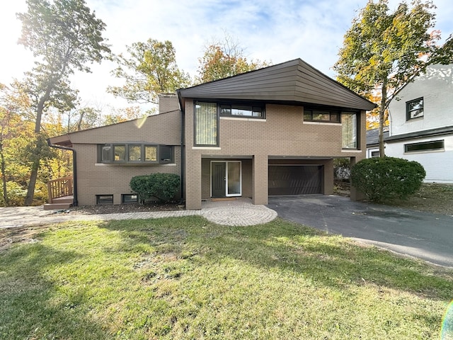 view of front of home with a front yard and a garage