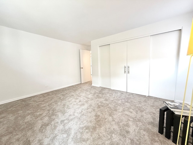 unfurnished bedroom with a closet and carpet flooring