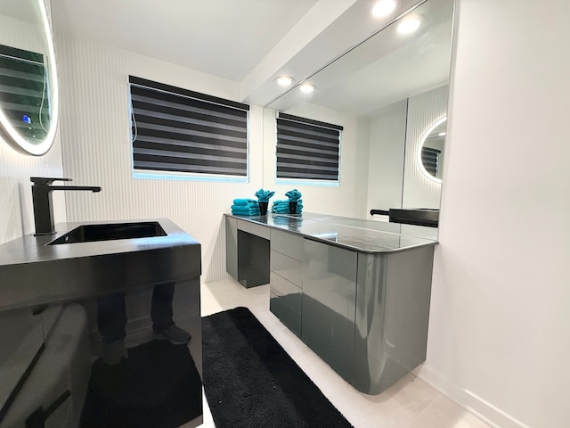 bathroom with sink and tile patterned flooring