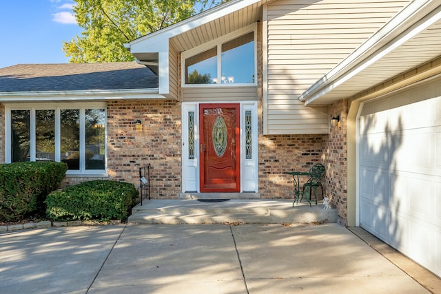 doorway to property with a garage