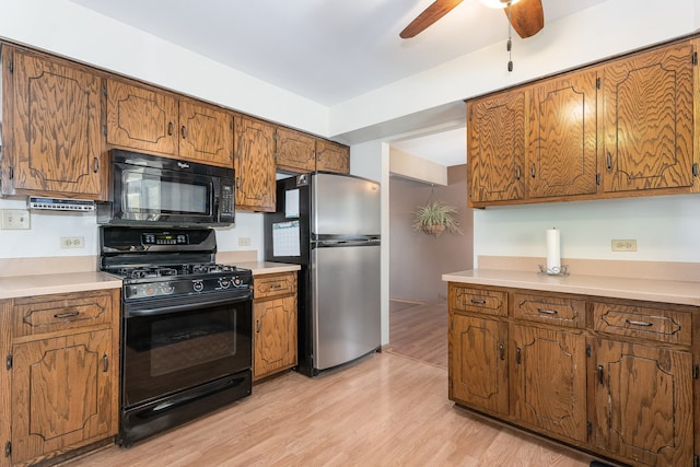 kitchen featuring light hardwood / wood-style flooring, black appliances, and ceiling fan