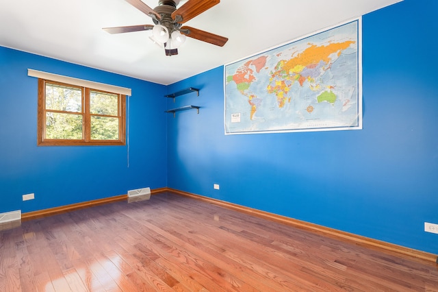 unfurnished room featuring ceiling fan and wood-type flooring