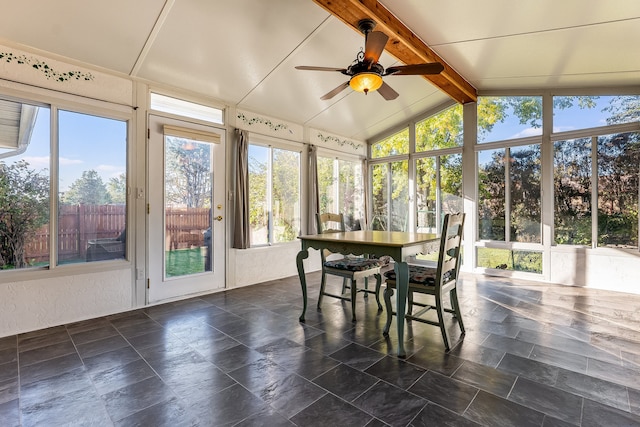 sunroom featuring lofted ceiling with beams, a healthy amount of sunlight, and ceiling fan