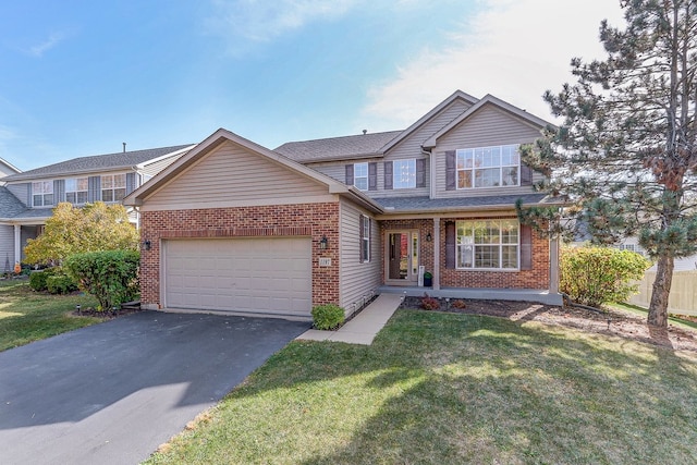 view of front of property featuring a front yard and a garage