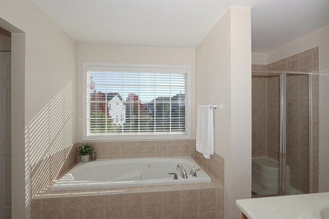 bathroom featuring vanity and plus walk in shower