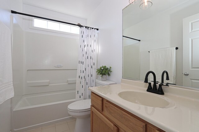 full bathroom featuring toilet, vanity, shower / bath combination with curtain, and tile patterned flooring