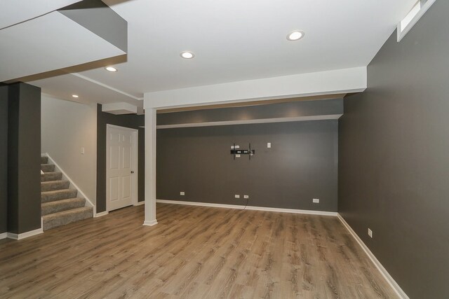 basement with hardwood / wood-style floors